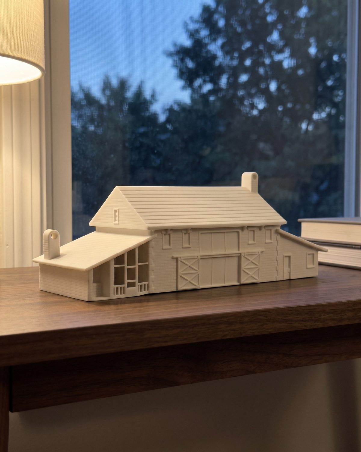 A finished white barn house piece on a walnut console by a window at dusk, in a generated picture
